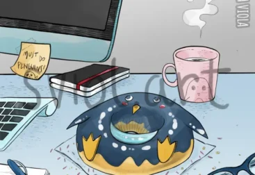 on a desk, donut in the shape of a penguin